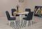 Ensemble de table ronde extensible et de 4 chaises Malva en bois blanc et tissu bleu marine.