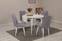 Uitbreidbare ronde eettafelset en 4 Malva wit houten stoelen met lichtgrijze stoffen bekleding.